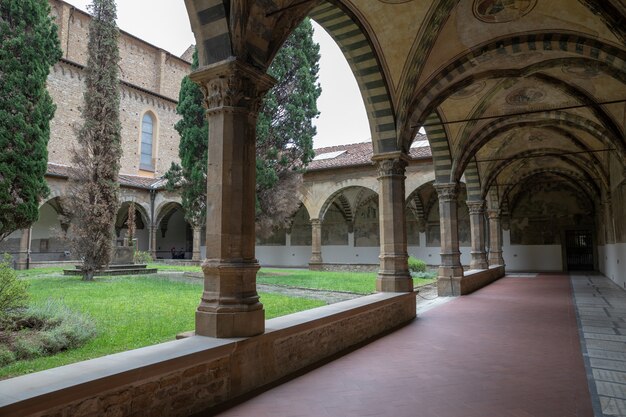 Florence, Italy - June 24, 2018: Panoramic view of inner garden of Basilica of Santa Maria Novella. it is the first great basilica in Florence, and is the city's principal Dominican church