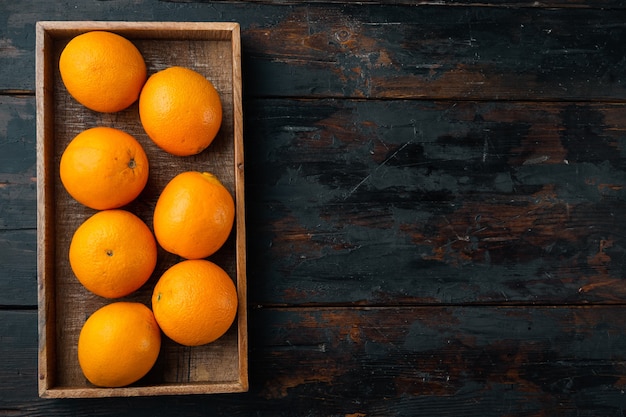 Florida county orange, healthy fruits set, in wooden box, on old dark wooden table, top view flat lay