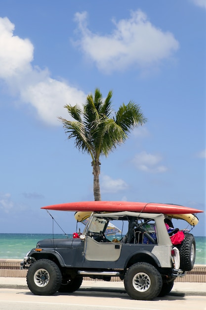 Florida surfer car with surfboard blue sky