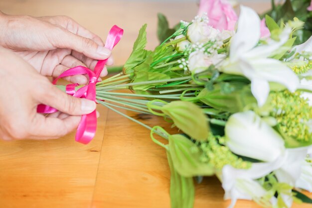 Florist  Arranging beautiful Artificial vest at flower shop