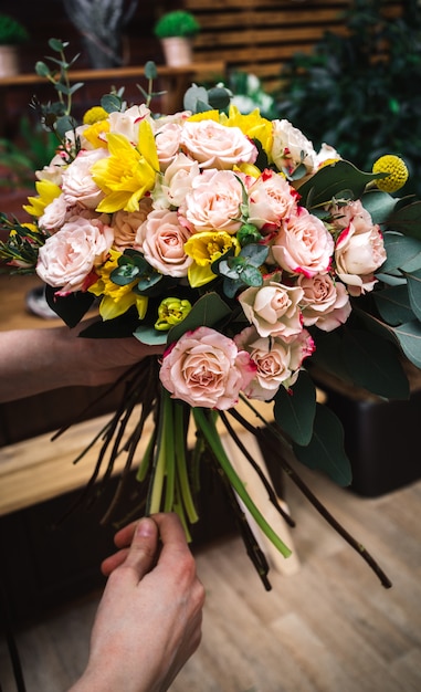 Florist demonstrating finished floral bunch