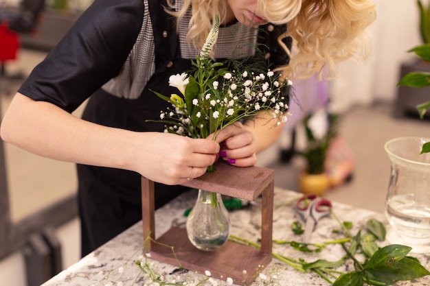 Florist makes a bouquet. Flower composition close-up