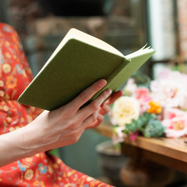 Florist reading a book in the flower shop