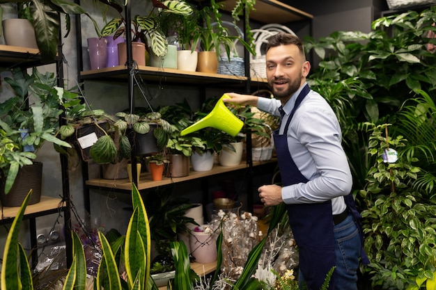 Florist watering flowers in the garden center