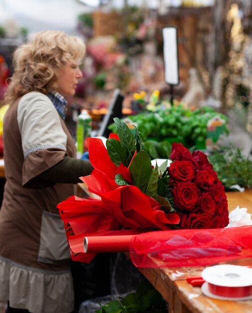 Florist with professional clothing in a shop