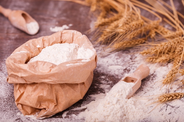 Flour in  bag and wooden spoon