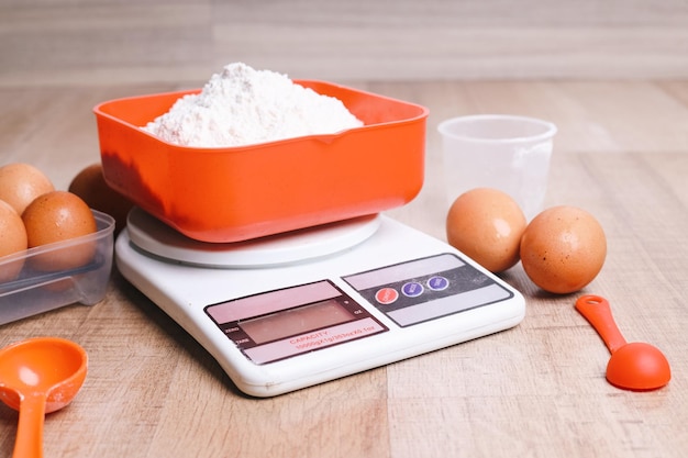 Photo flour on digital scale with eggs baking concept