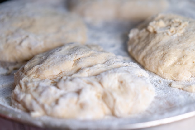 Flour dough sprinkled on a tray