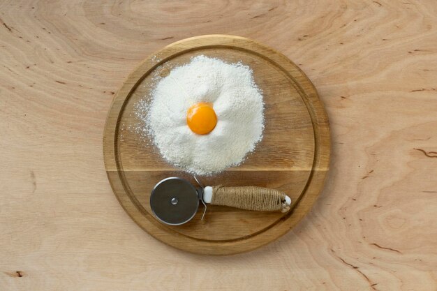 Flour and egg yolk on cutting board