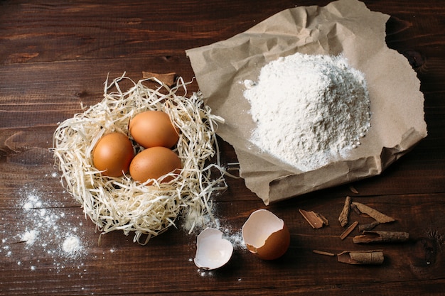 Flour and eggs on a wooden board