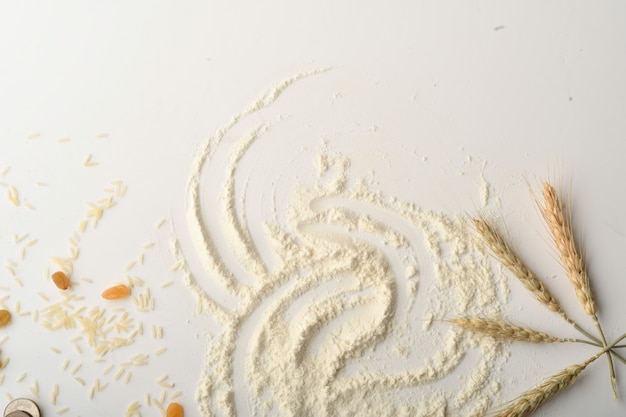 Flour, wheat, rice, raisins and coins on a white background