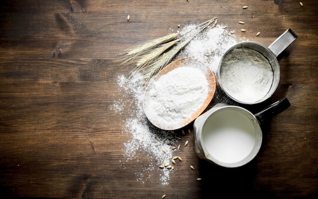 Flour with milk in a jug and spikelets