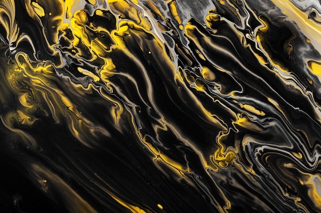 검은색과 노란색 페인트의 흐름입니다. 검은 파도와 곱슬 머리에 노란색 내포물. 대리석 효과 배경 또는 질감입니다. 유체 예술.