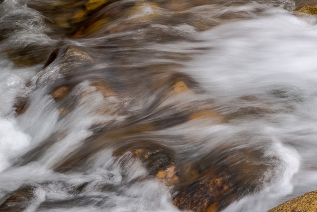The flow of a mountain river with rounded stones