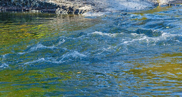 flow of water and spray from a stone close up