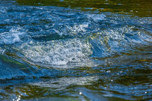 Flow of water and spray from a stone close up