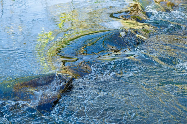 flow of water and spray from a stone close up