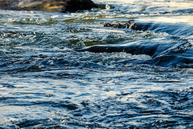 Flow of water and spray from a stone