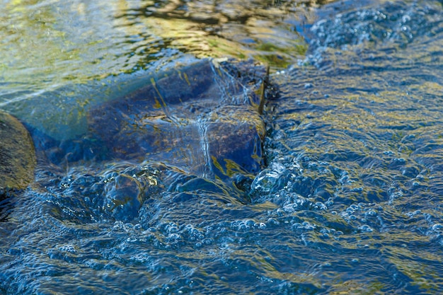 Flow of water and spray from a stone