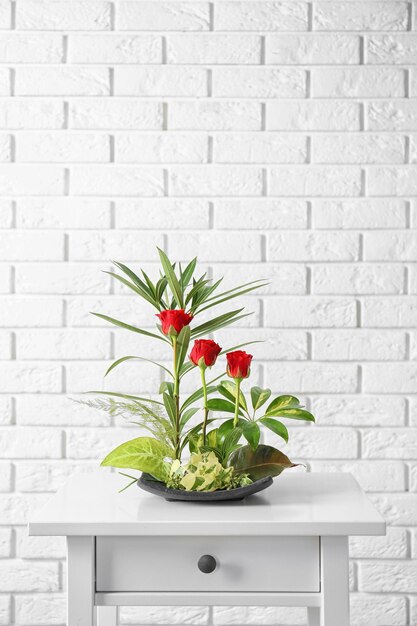 Flower arrangement on brick wall background