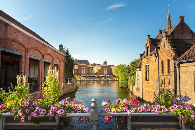 Flower bed, river canal in old tourist town on