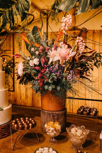 Flower bouquet of top of a dessert table photo