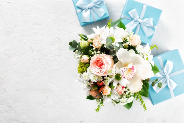 Flower bouquet with gift boxes Flat lay, top view