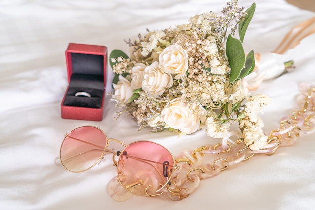 flower bouquet with sun glasses and ring