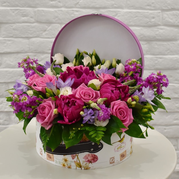 Flower composition in original hatbox. Beautiful flowers in stylish hat box.