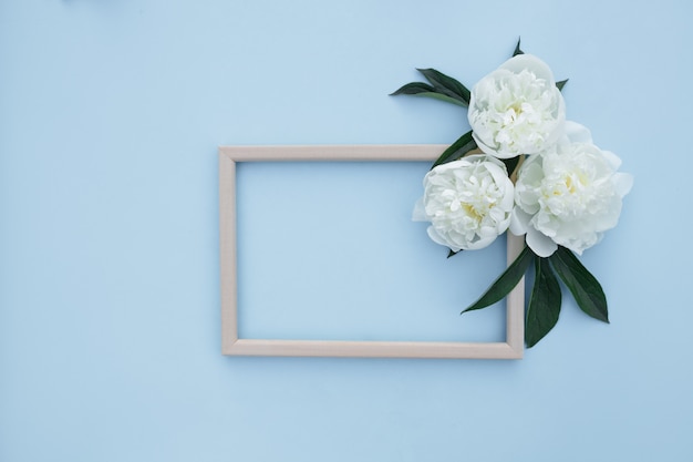 Flower composition of peonies. Spring, floral background. Frame with white flowers on a light background.