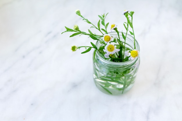 Flower decoration in glass bottle on the table