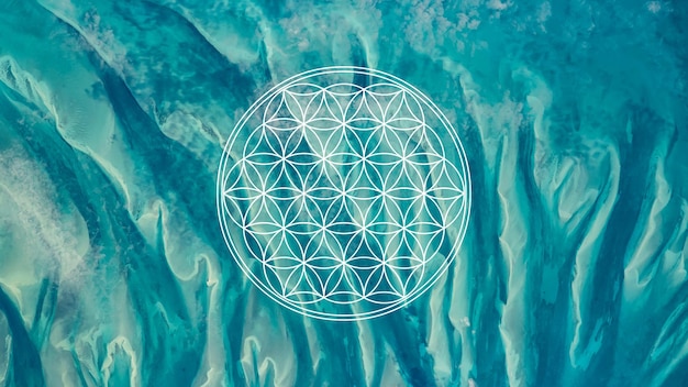 Photo flower of life sacred geometry symbol on turquoise blue ocean waters background or hd wallpaper.