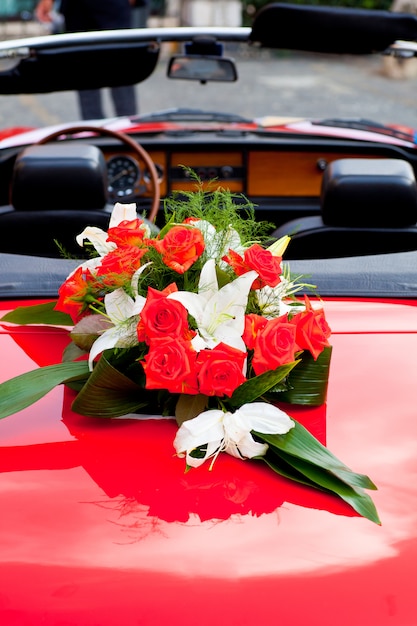 Flower's bouquet on a red car