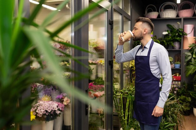 Flower seller on the background of the refrigerator with bouquets