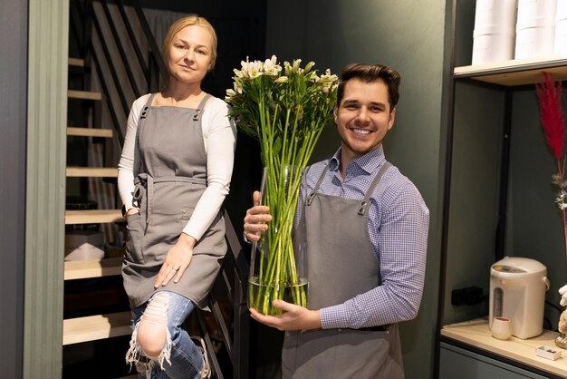 Flower shop employees kindly offer a choice of different bouquets