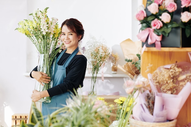 Flower shop owner removing big vase