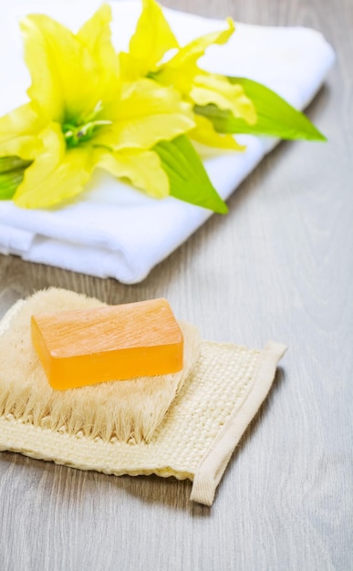 Flower on towel and soap on bast