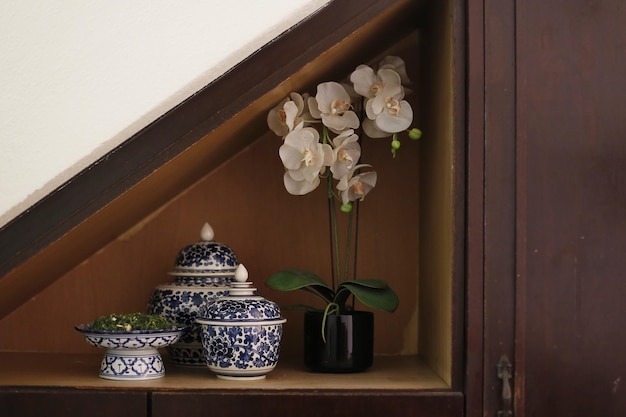 Photo flower vase by containers in shelf