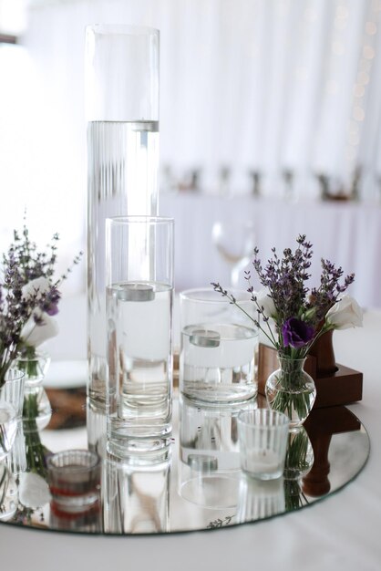 Photo flower vase on table against glass wall