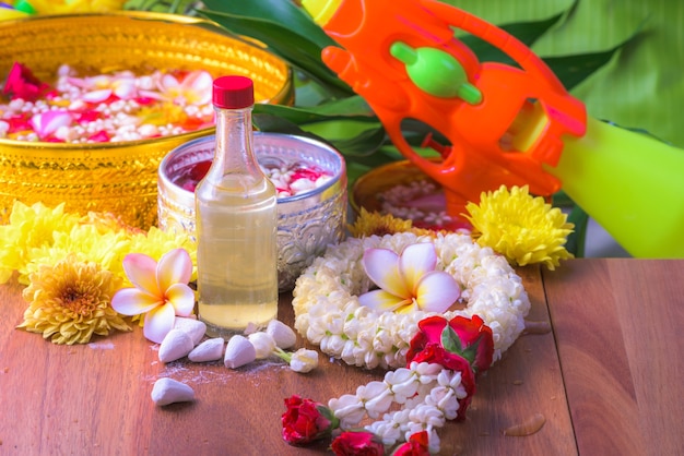 flower in water bowls and pipe gun on Banana leaf for Songkran Festival or Thai New Year