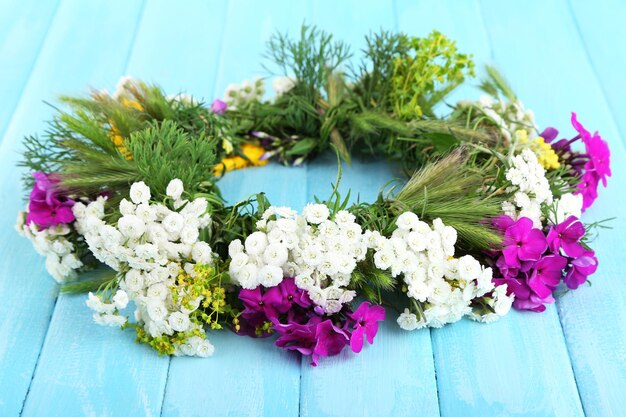 Flower wreath on wooden background