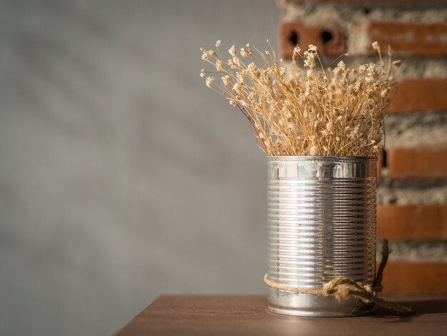 Flowering dried grass in aluminium pot for room decoration.