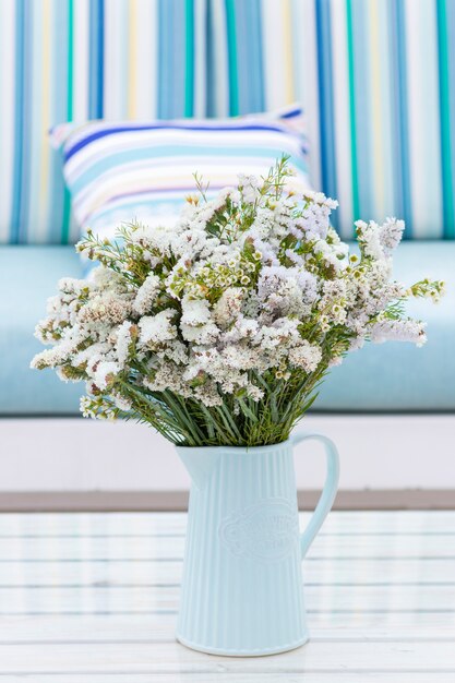 Flowers arrangement on table outdoors on the terrace of the house