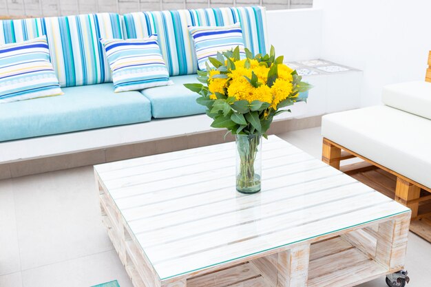 Flowers arrangement on table outdoors on the terrace of the house