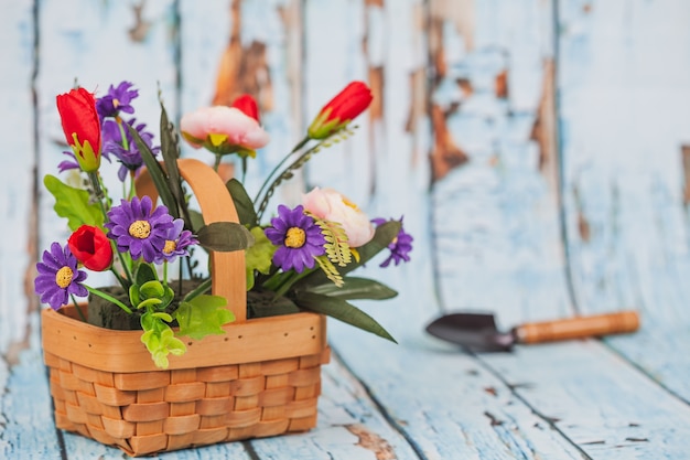 flowers in bamboo basket on wood background