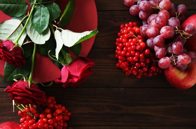 Flowers and berries for composition on wooden background