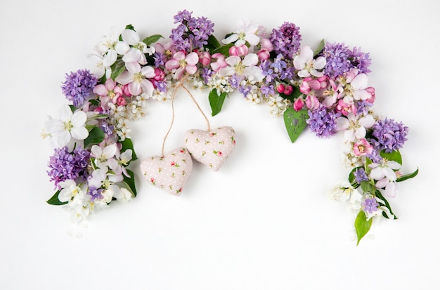  flowers of the bird cherry tree, lilac and apple trees lined with an arch and two hearts of fabric