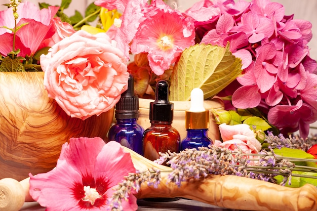 Flowers and bottles of essential oils for aromatherapy