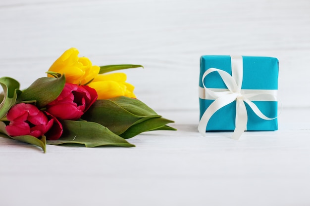 Photo flowers and a box with a gift.