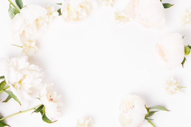 Flowers composition Frame made of romantic pink peony flowers on white background Flat lay top view copy space